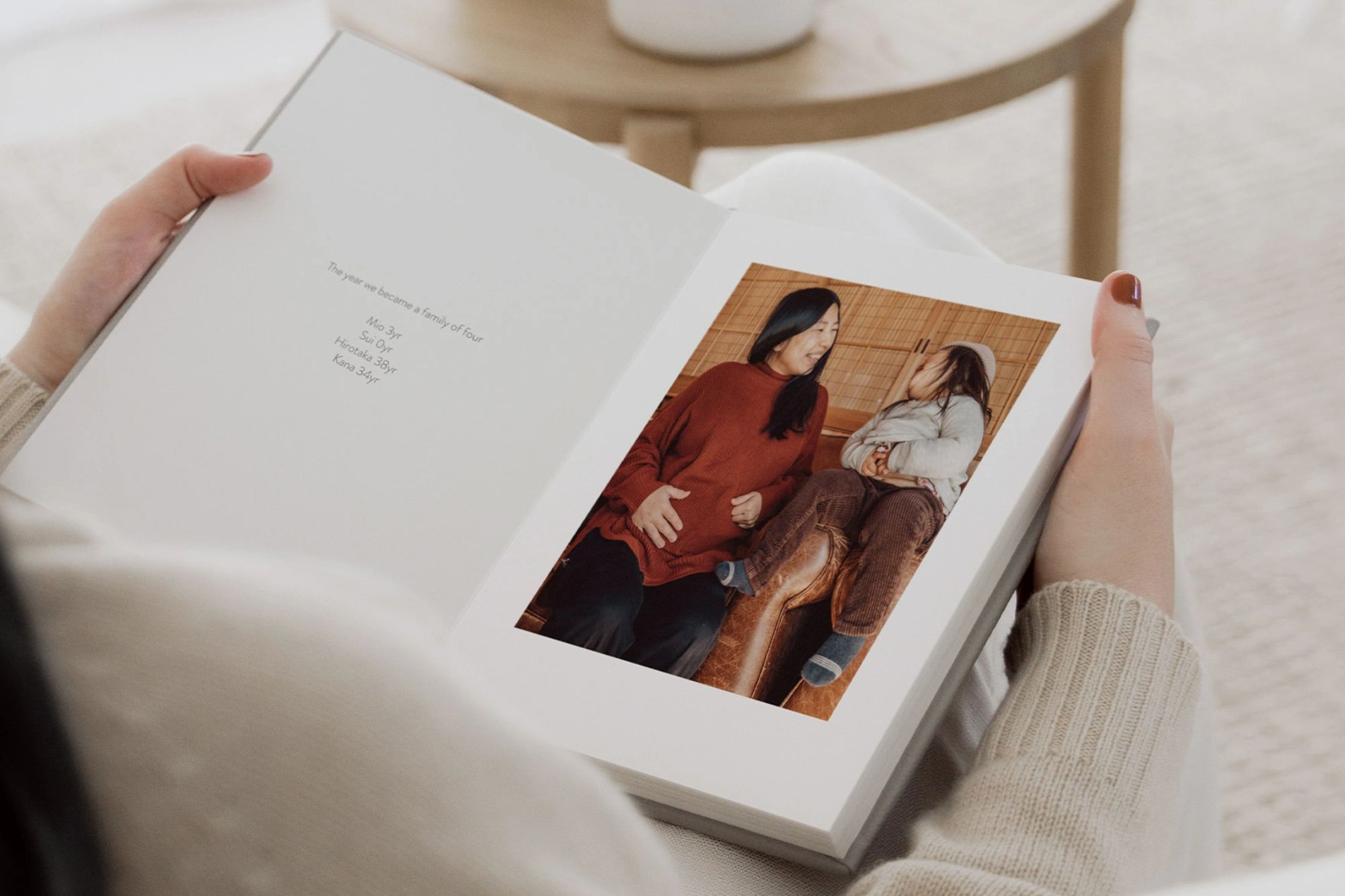 Woman holding open a Portrait Premium Family Photo Album.