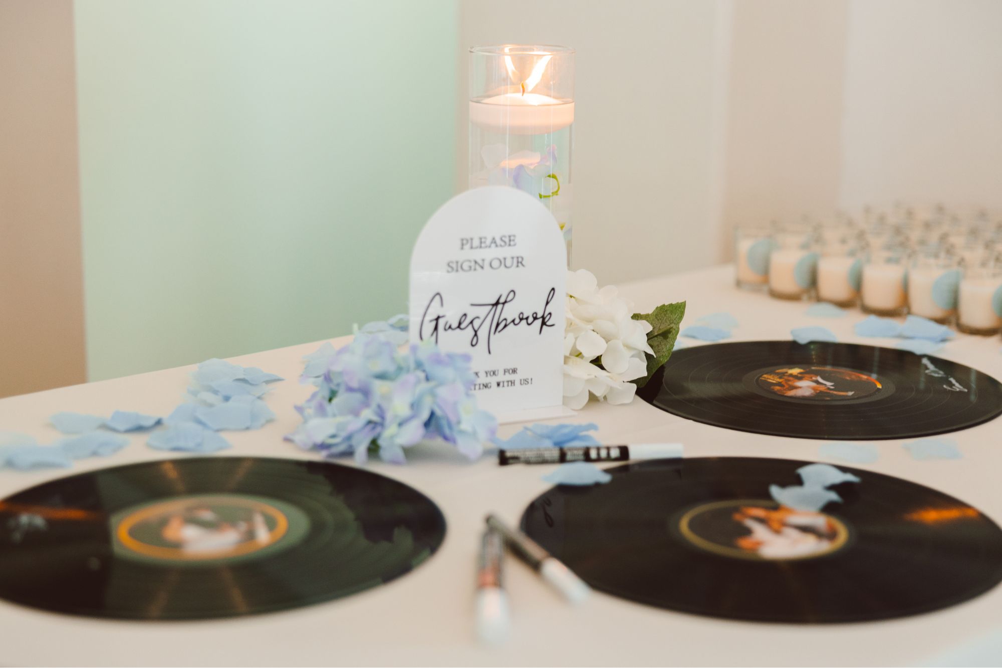 Photo of vinyl records with signatures on them at a wedding