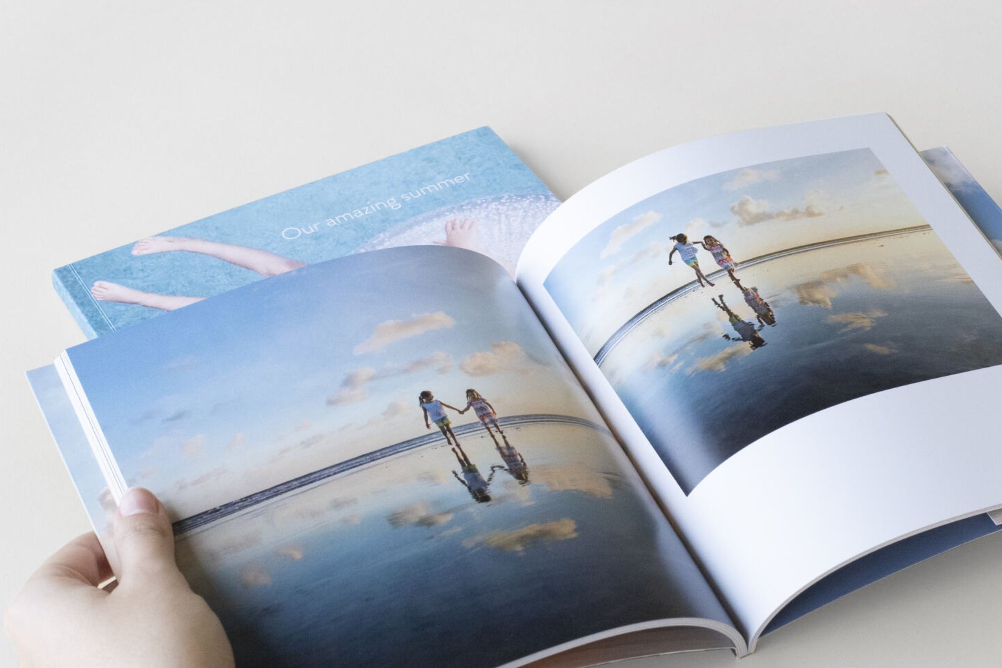 Softcover book with kids walking at the beach