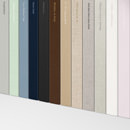Stack of Wedding Guest Books displaying various cover fabric options